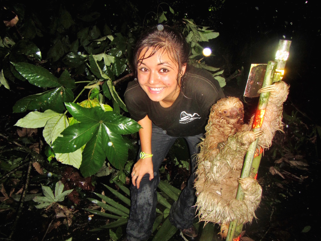 Ari posing next to a three-toed sloth in Costa Rica
