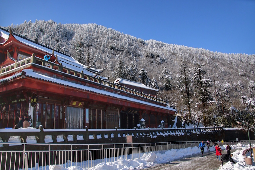 A snowy covered traditional Chinese-style building in Emeishan