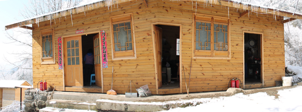 A slightly bad panoramic of the outside of Tiantai Shan. It consists of 3 rooms, the living quarters (the door on the left), the storage area (center), and the kitchen (door on the right). The bathroom in the little building at the very back left corner of the photo.